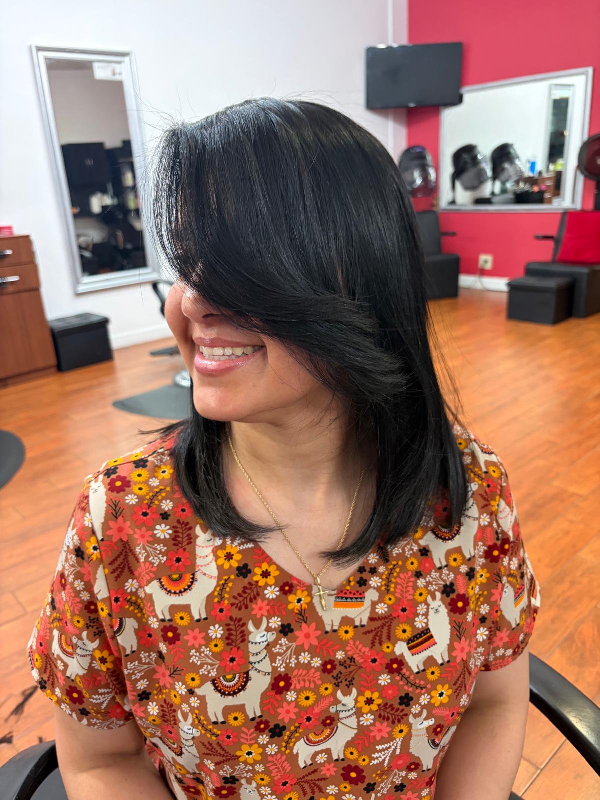 Sleek cut and style — glossy black lob with bangs
